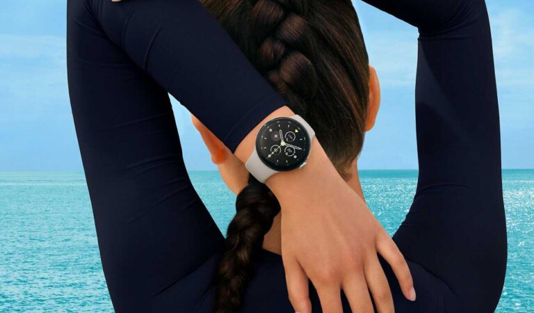 Woman stretching her arms, wearing a Fitbit smartwatch. AI wellness coach.