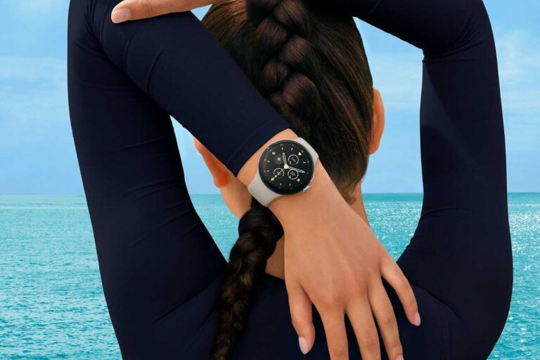 Woman stretching her arms, wearing a Fitbit smartwatch. AI wellness coach.