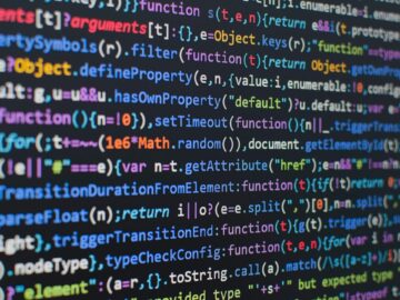 Colorful JavaScript code on a black screen, displaying functions and variables. Illustrates manual code and syntax, key for devs.
