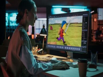 Video game developer creating a 3D character on screen, illustrating generative AI and its impact on creators.
